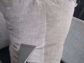 A cushion being cleaned by steam cleaning